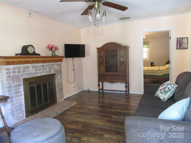 1051 S Brady Ave, Newton, NC 28658 - living area with wood finished floors, ceiling fan, a fireplace, a textured ceiling, and baseboards