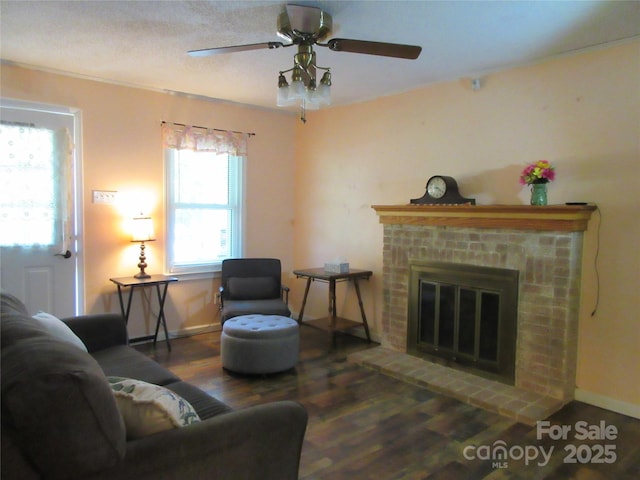 1051 S Brady Ave, Newton, NC 28658 - living room with wood finished floors, a ceiling fan, a brick fireplace, and baseboards