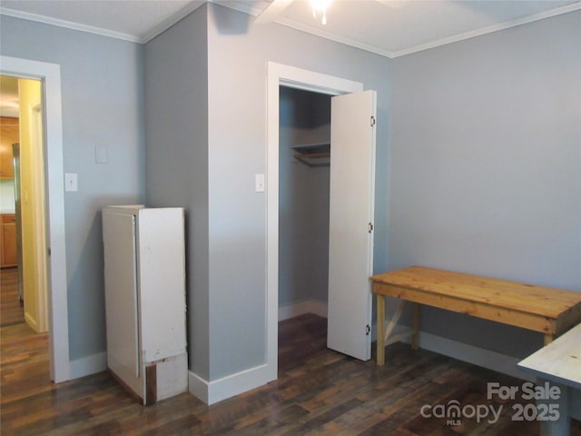 1051 S Brady Ave, Newton, NC 28658 - bedroom featuring wood finished floors, ornamental molding, baseboards, and a walk in closet