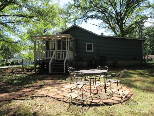 1051 S Brady Ave, Newton, NC 28658 - back of property with a patio area, outdoor dining space, stairs, and a deck
