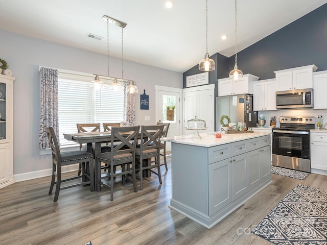 805 Brookmont Ave, Salisbury, NC 28146 - kitchen with stainless steel appliances, high vaulted ceiling, decorative backsplash, light countertops, and white cabinetry