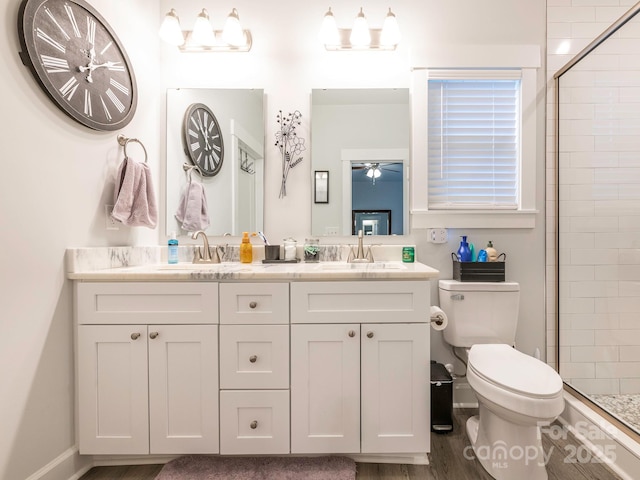 805 Brookmont Ave, Salisbury, NC 28146 - bathroom featuring toilet, double vanity, tiled shower, and wood finished floors