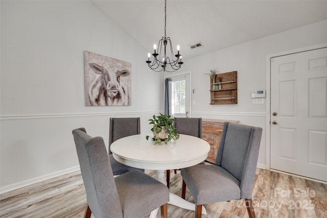 4712 Avalon Forest Ln, Charlotte, NC 28269 - dining space with a chandelier, light wood finished floors, vaulted ceiling, and baseboards