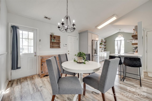 4712 Avalon Forest Ln, Charlotte, NC 28269 - dining space featuring a chandelier, lofted ceiling, and light wood-style flooring
