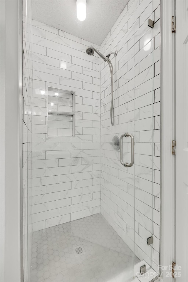 4712 Avalon Forest Ln, Charlotte, NC 28269 - bathroom featuring a stall shower and a textured ceiling