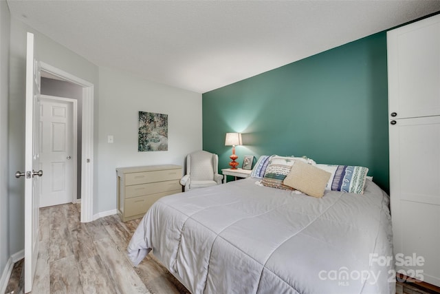 4712 Avalon Forest Ln, Charlotte, NC 28269 - bedroom with light wood finished floors and baseboards