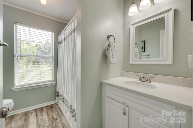 4712 Avalon Forest Ln, Charlotte, NC 28269 - full bathroom with vanity, toilet, healthy amount of natural light, wood finished floors, and ornamental molding