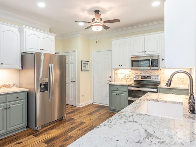 725 Old State St SW, Concord, NC 28027 - kitchen featuring appliances with stainless steel finishes, dark wood-type flooring, ceiling fan, a sink, and white cabinetry