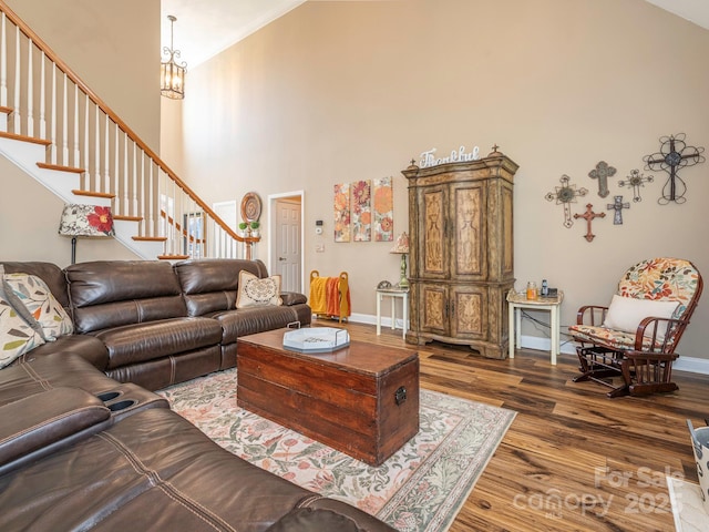 725 Old State St SW, Concord, NC 28027 - living area with a towering ceiling, dark wood-style floors, a chandelier, stairs, and baseboards