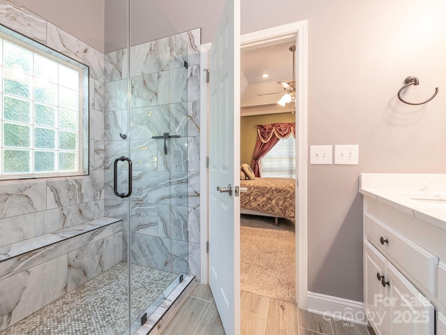 725 Old State St SW, Concord, NC 28027 - bathroom with connected bathroom, a shower stall, vanity, wood finish floors, and baseboards