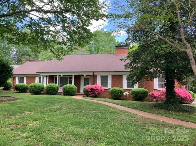 1614 Statesville Blvd, Salisbury, NC 28144 - ranch-style house with a front yard, a chimney, and brick siding