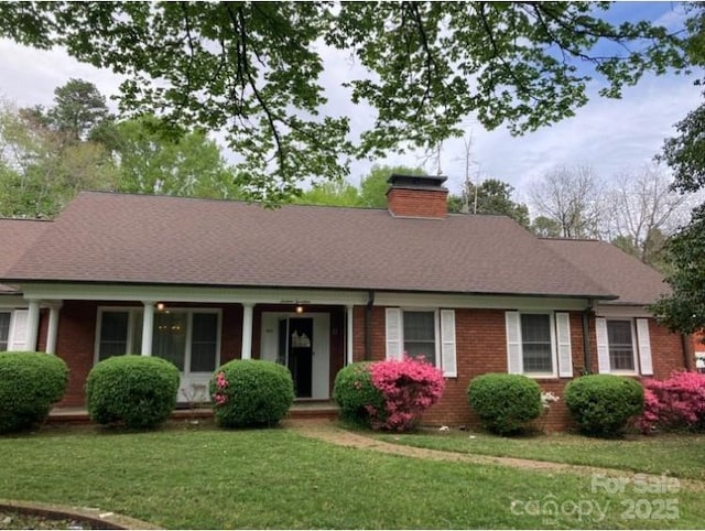 1614 Statesville Blvd, Salisbury, NC 28144 - view of front facade featuring brick siding, a front yard, a chimney, and covered porch