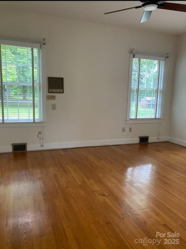 1614 Statesville Blvd, Salisbury, NC 28144 - spare room featuring ceiling fan, wood finished floors, and plenty of natural light