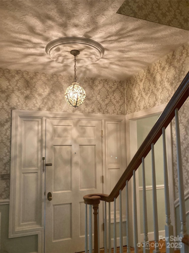 1614 Statesville Blvd, Salisbury, NC 28144 - entryway with wallpapered walls, stairs, and a chandelier