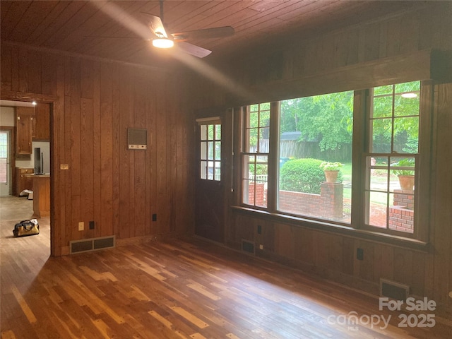 1614 Statesville Blvd, Salisbury, NC 28144 - unfurnished room featuring wooden walls, wood finished floors, wood ceiling, healthy amount of natural light, and a ceiling fan