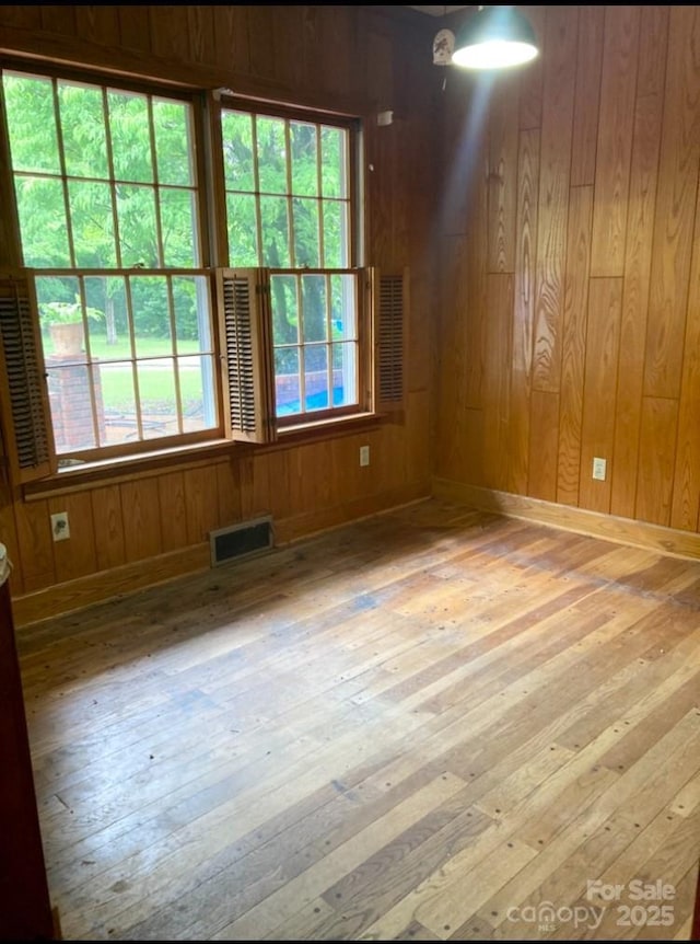 1614 Statesville Blvd, Salisbury, NC 28144 - empty room with hardwood / wood-style floors and wooden walls