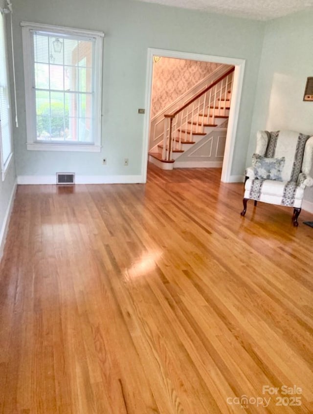 1614 Statesville Blvd, Salisbury, NC 28144 - unfurnished living room with stairway and wood finished floors