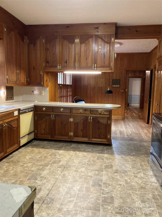 1614 Statesville Blvd, Salisbury, NC 28144 - kitchen featuring light countertops, wooden walls, stainless steel range, dishwashing machine, and light stone finish floors