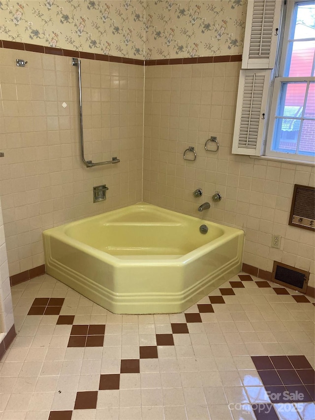 1614 Statesville Blvd, Salisbury, NC 28144 - full bathroom featuring a bath, wallpapered walls, tile walls, and tile patterned floors