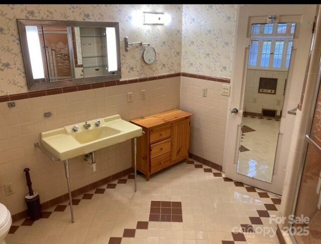 1614 Statesville Blvd, Salisbury, NC 28144 - bathroom with wallpapered walls, a wainscoted wall, and tile walls