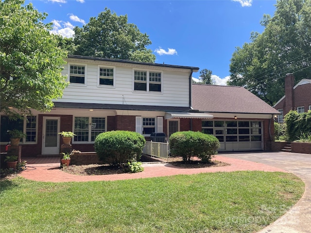 1614 Statesville Blvd, Salisbury, NC 28144 - view of front facade featuring driveway, a front yard, a garage, and brick siding