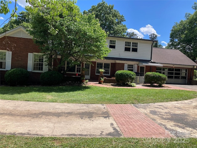 1614 Statesville Blvd, Salisbury, NC 28144 - view of front facade featuring brick siding, a front lawn, and a garage