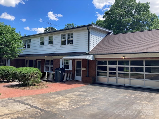 1614 Statesville Blvd, Salisbury, NC 28144 - view of front facade featuring brick siding, an attached garage, asphalt driveway, and a shingled roof