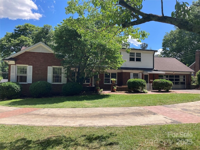 1614 Statesville Blvd, Salisbury, NC 28144 - view of front facade featuring brick siding, a front yard, a garage, and driveway