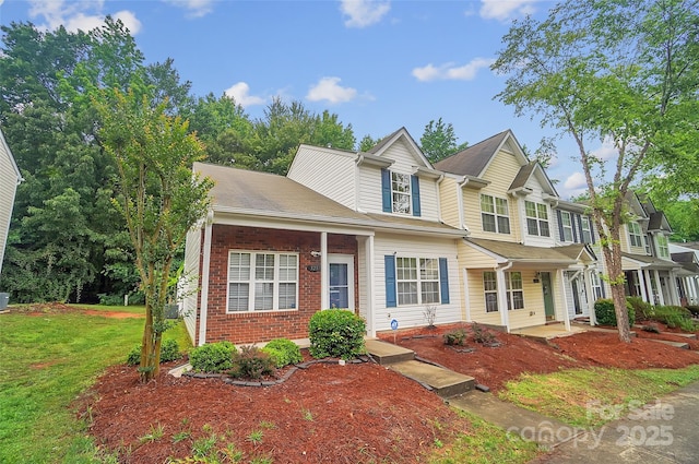 5237 Ficus Tree Ln, Charlotte, NC 28215 - traditional-style house featuring brick siding, a front lawn, and covered porch