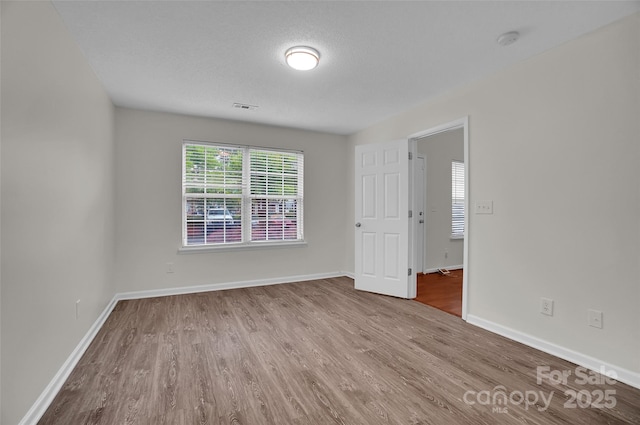 5237 Ficus Tree Ln, Charlotte, NC 28215 - spare room with wood finished floors and a smoke detector