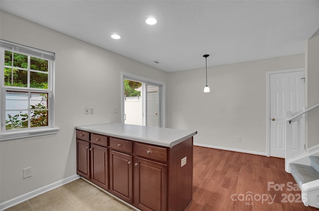5237 Ficus Tree Ln, Charlotte, NC 28215 - kitchen with a peninsula, healthy amount of natural light, light countertops, recessed lighting, and light wood-type flooring