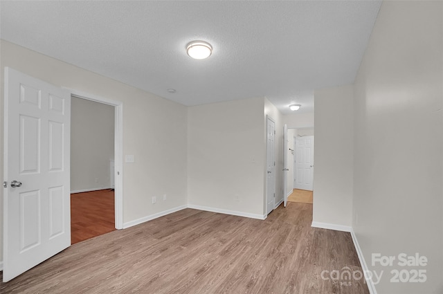 5237 Ficus Tree Ln, Charlotte, NC 28215 - unfurnished room with wood finished floors and a textured ceiling