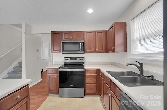 5237 Ficus Tree Ln, Charlotte, NC 28215 - kitchen with stainless steel appliances, light countertops, brown cabinets, and recessed lighting