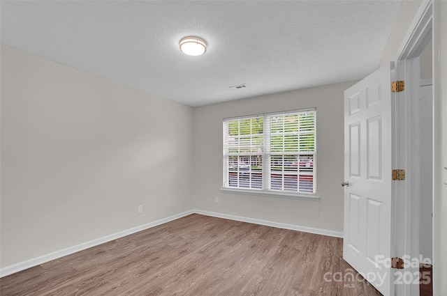 5237 Ficus Tree Ln, Charlotte, NC 28215 - empty room featuring wood finished floors and a textured ceiling