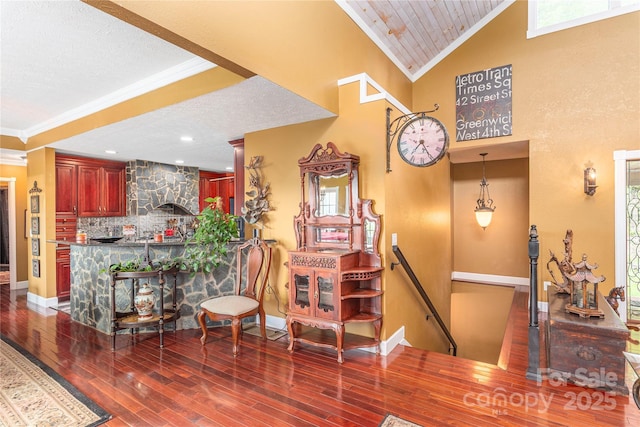 1706 Rock House Cove Rd, Clyde, NC 28721 - staircase featuring crown molding, wood finished floors, baseboards, a textured ceiling, and a towering ceiling