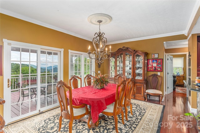 1706 Rock House Cove Rd, Clyde, NC 28721 - dining room with a chandelier, hardwood / wood-style flooring, and ornamental molding