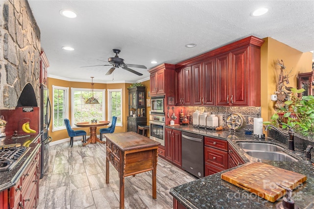 1706 Rock House Cove Rd, Clyde, NC 28721 - kitchen with stainless steel appliances, reddish brown cabinets, a sink, recessed lighting, and a ceiling fan