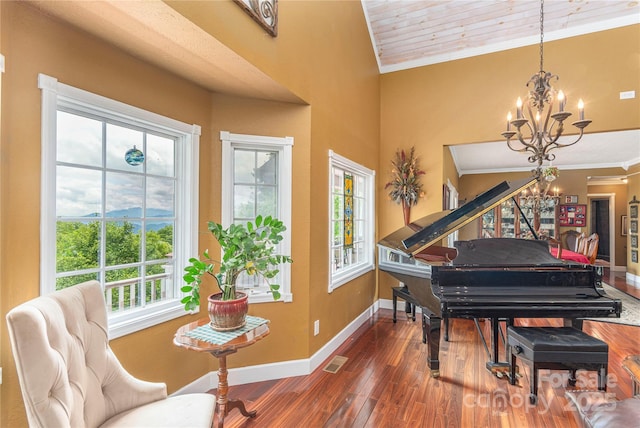 1706 Rock House Cove Rd, Clyde, NC 28721 - living area featuring a chandelier, crown molding, hardwood / wood-style floors, and baseboards
