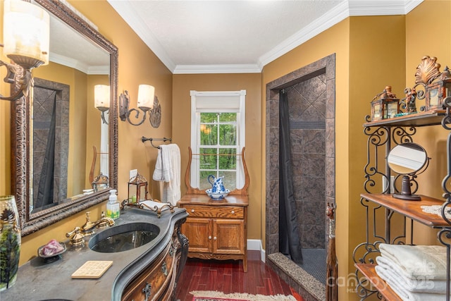 1706 Rock House Cove Rd, Clyde, NC 28721 - full bathroom featuring wood finished floors, a tile shower, vanity, crown molding, and baseboards