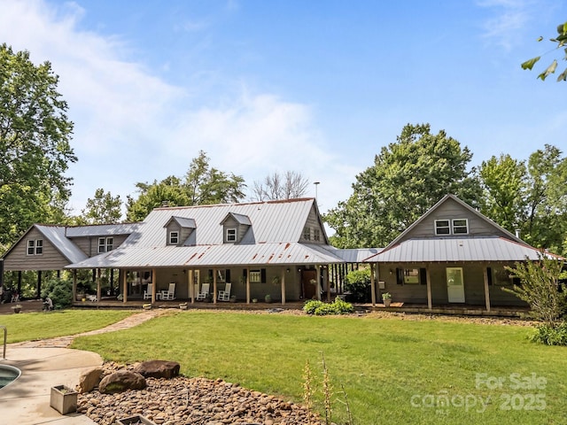 1433 Kern Carlton Rd, Salisbury, NC 28146 - back of property featuring a porch, a lawn, and a metal roof