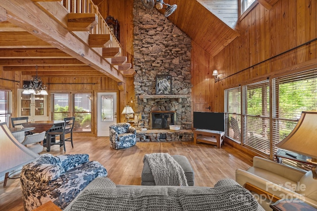 1433 Kern Carlton Rd, Salisbury, NC 28146 - living room featuring wood walls, high vaulted ceiling, a fireplace, hardwood / wood-style flooring, and a chandelier