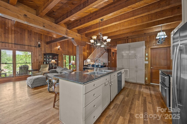 1433 Kern Carlton Rd, Salisbury, NC 28146 - kitchen with wood walls, beam ceiling, appliances with stainless steel finishes, wood finished floors, and a chandelier