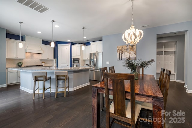 1284 Independence St, Fort Mill, SC 29708 - dining room with dark wood finished floors, a chandelier, recessed lighting, and baseboards