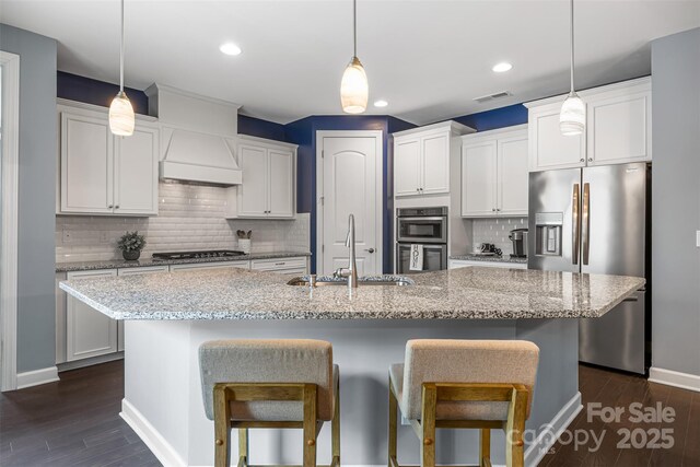 1284 Independence St, Fort Mill, SC 29708 - kitchen with a sink, stainless steel appliances, premium range hood, a kitchen island with sink, and a breakfast bar area