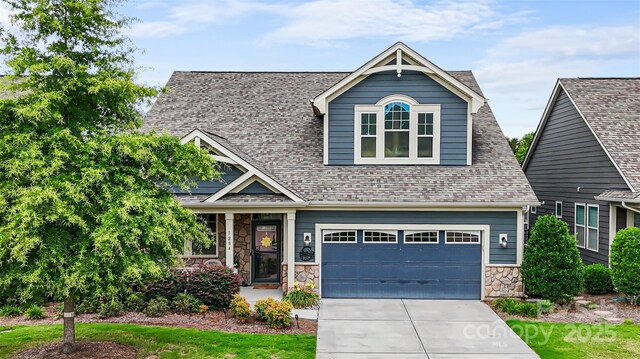 1284 Independence St, Fort Mill, SC 29708 - craftsman-style house featuring concrete driveway, stone siding, an attached garage, and roof with shingles