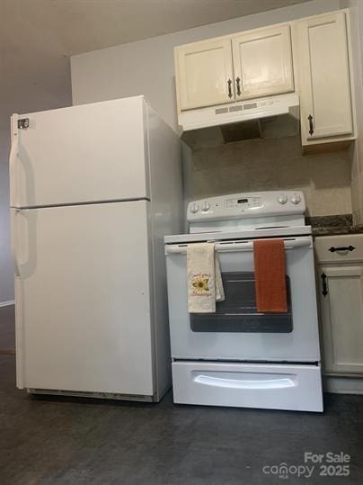 120 Booker St, Wingate, NC 28112 - kitchen featuring white appliances, under cabinet range hood, and dark countertops