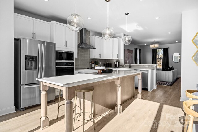 3225 Drift St Unit 63End, Charlotte, NC 28278 - kitchen featuring stainless steel appliances, wall chimney range hood, a peninsula, a center island, and tasteful backsplash