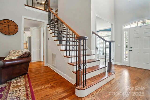 7006 Nesbit Rd, Waxhaw, NC 28173 - entryway with a high ceiling, light wood finished floors, stairway, and baseboards