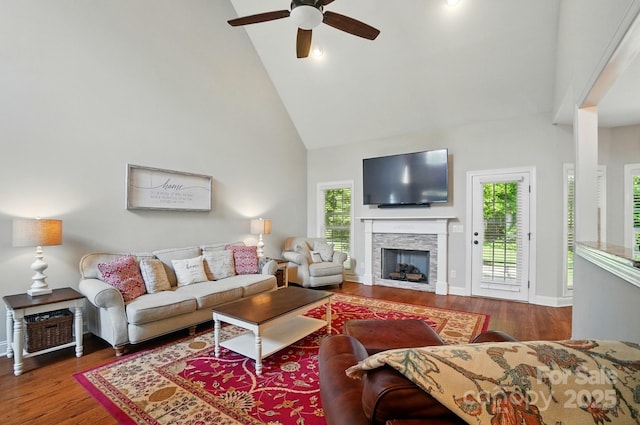 7006 Nesbit Rd, Waxhaw, NC 28173 - living room with ceiling fan, wood finished floors, a fireplace, high vaulted ceiling, and baseboards