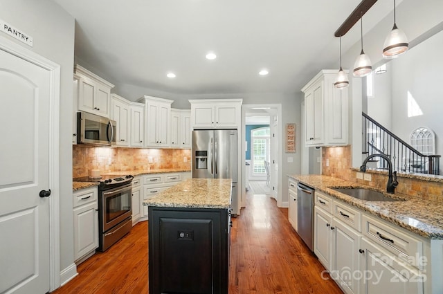 7006 Nesbit Rd, Waxhaw, NC 28173 - kitchen with appliances with stainless steel finishes, a sink, tasteful backsplash, recessed lighting, and white cabinetry